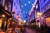 London-street-with-people-eating-outside-by-night