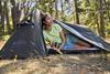 Woman sitting inside Mountain Warehouse tent