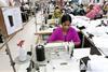Bangladeshi woman works in a garments factory in Ashulia Savar in Dhaka on September 24, 2013. © palash khan/Alamy Live News