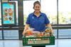 Aldi worker carrying Too Good To Go food box