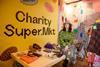 Charity-Super.Mkt-at-Brent-Cross,-branded-hoarding-and-accessories-table