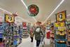 Supermarket aisles at Christmas, showing shoppers and promotional decorations