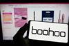 Boohoo logo on smarphone in front of the webpage