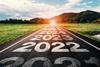A road stretching into the distance with the dates 2022, 2023, 2024 and 2025 marked on the tarmac