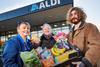 Aldi staff and customers with food packages as part of the Feed the Nation campaign
