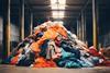 Huge pile of returned clothes in a warehouse