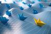 Paper boats on undulating sea with grid on top