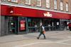 Wilko store on high street with man walking past