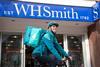 Deliveroo rider outside a WHSmith store