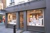 Luxury retailer Mulberry has reported a slump in full-year pre-tax profits, but said it has seen a 'positive uplift' in sales since November.