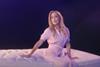 Actress Gillian Anderson sitting on a bed in a Dreams advert