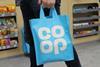 Customer carrying Co-op tote bag