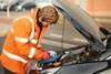 Halfrod auto repair employee working on car engine