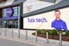Exterior of Currys store with a sign showing an employee and text reading: 'Talk tech'