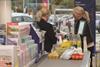 Retail staff working at a check-out