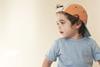 Child wearing Kidly t-shirt and cap