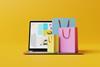 Laptop with the website of the online store and shopping bags