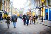 Blurred image of shoppers on a busy high street