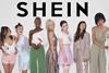 Eight models and a llama in front of a Shein banner