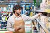 Supermarket employee checking stock