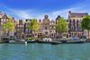 Historic gabled houses along Singel canal in Amsterdam
