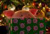 Percy Pig peering over a present in the M&S Christmas advert