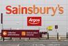 Exterior of Sainsbury's store showing Argos branding and signs for collection point and click-and-collect groceries