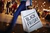 Lady holding a black Friday shopping bag