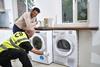 AO engineer installing a washing machine in a customer's kitchen