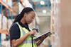 Warehouse worker using scanner and tablet