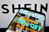 Shein website on photo in front of a Shein logo background