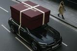 A giant Lookfantastic gift box on roof of an Uber Eats delivery car