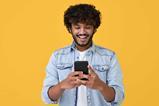 Young-man-looking-at-phone-and-smiling-index