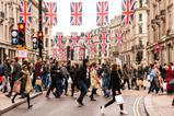 Tourists and shoppers crossing busy Regents Street