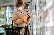 Woman wearing face mask shopping in supermarket