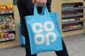 Customer carrying Co-op tote bag