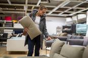 Woman buying a sofa in a furniture store