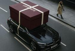 A giant Lookfantastic gift box on roof of an Uber Eats delivery car