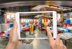 Customer using a tablet to look at items in store with augmented reality labels saying: 'Special price'