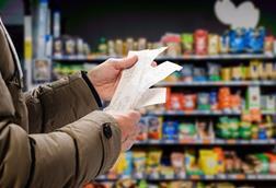 Customer reading grocery shopping receipt