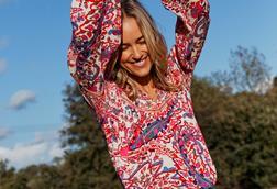 Woman wearing FatFace top and shorts