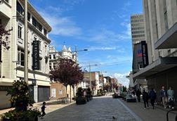 Middlesbrough town centre showing people walking past shuttered Debenhams and House of Fraser stores