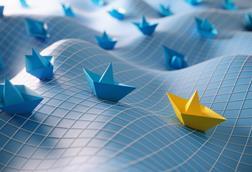 Paper boats on undulating sea with grid on top