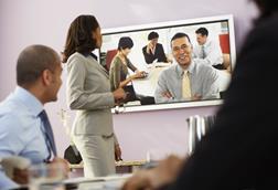 Staff in a boardroom getting video training