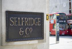 Brass Selfridges sign on London store wall