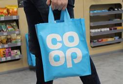 Customer carrying Co-op tote bag