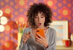 Woman looking at her phone in a Temu advert