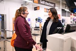 Sainsbury-employee-with-headset-talking-to-customer-in-store