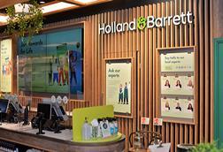 The use of natural materials like timber along with planting can create a more calming environment for shoppers - Holland and Barrett chelmsford