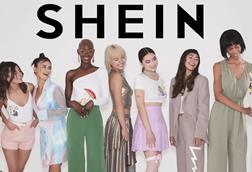 Eight models and a llama in front of a Shein banner